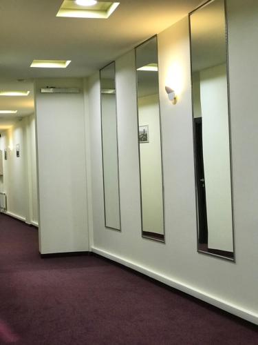 a row of mirrors in an office hallway at Hobby Hotel in Yerevan