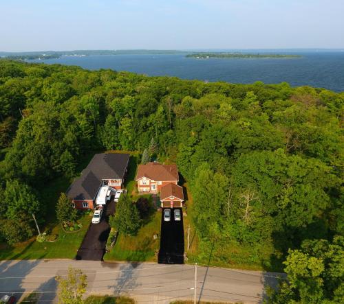 an aerial view of a house in the woods at Tucked Inn the Harbour B&B in Victoria Harbour