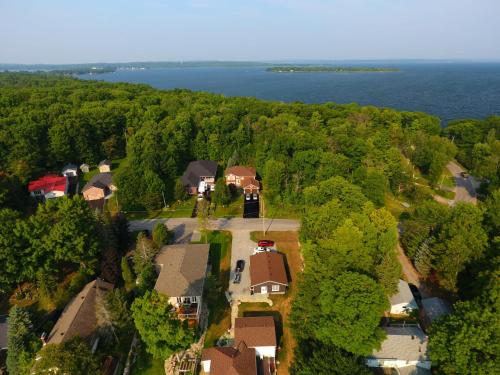an aerial view of a house with trees and water at Tucked Inn the Harbour B&B in Victoria Harbour