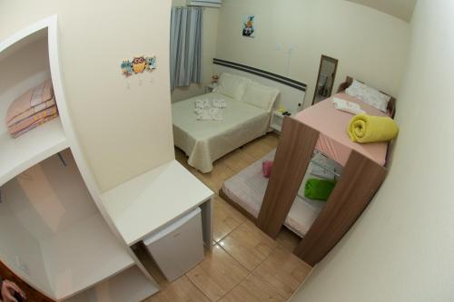a small room with a bed and a couch at Pousada Fiedler E Anacleto in Penha