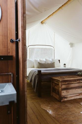 a bedroom with a bed in a tent at Under Canvas Mount Rushmore in Keystone
