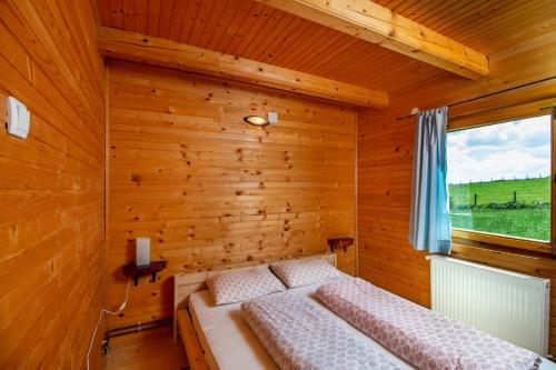 a room with two beds in a wooden room at Boskovica Brvnare in Žabljak