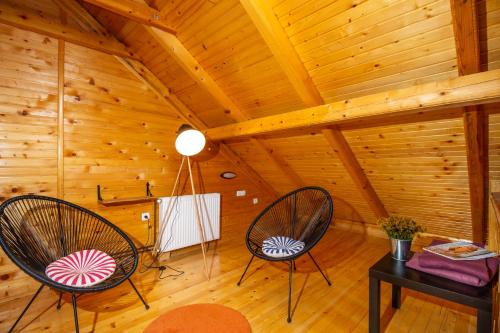 two chairs in a room with a wooden ceiling at Boskovica Brvnare in Žabljak