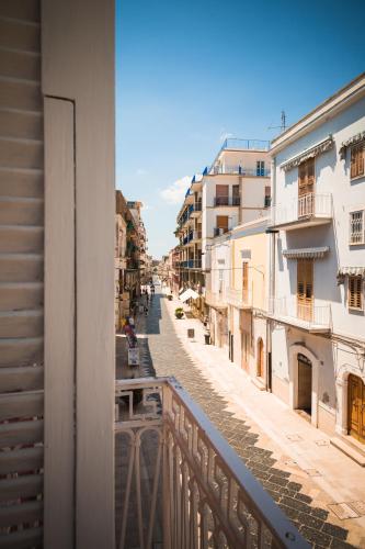 a view from a balcony of a street with buildings at Diomede Rooms - Manfredi Homes&Villas in Manfredonia
