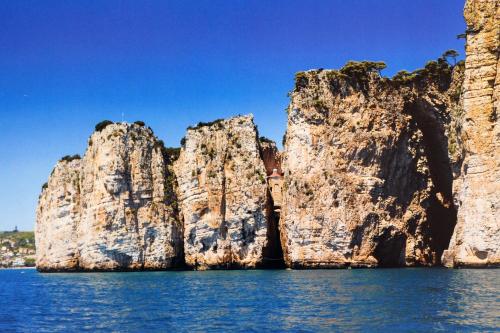 a group of large rocks in the water at I due mari in Gaeta