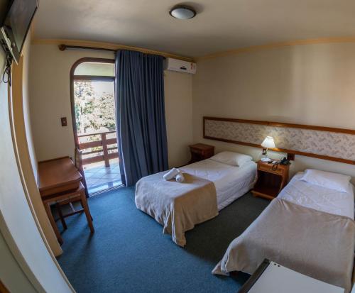 Katil atau katil-katil dalam bilik di Via Genova Parque Hotel