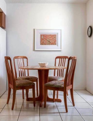 a wooden table with two chairs and a bowl on it at Shell Motel Hollywood in Hollywood