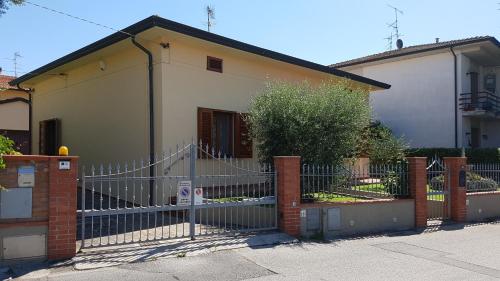a fence in front of a house at Casa Magnolia in Arena Metato