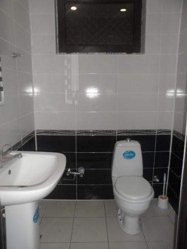 a bathroom with a toilet and a sink at VM Hostel in Ganja