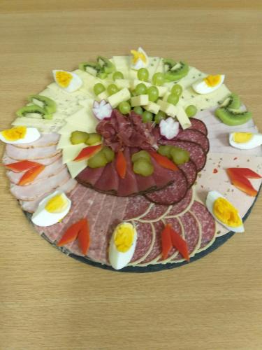 a plate of food with meat and vegetables on a table at Pension Berghof in Breitenbrunn