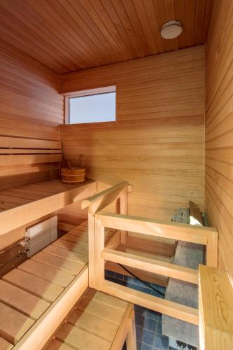 an empty sauna with wooden walls and wooden floors at Luxury City Center Apartments in Helsinki