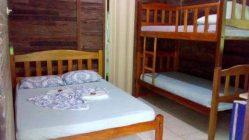 a room with two bunk beds and a bed with a mattress at Amazon Hostel & Eventos in Iranduba