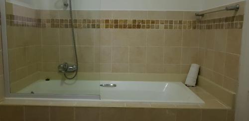 a bathroom with a bath tub with a shower at Ocean View Villas Unit G07 in Port Edward