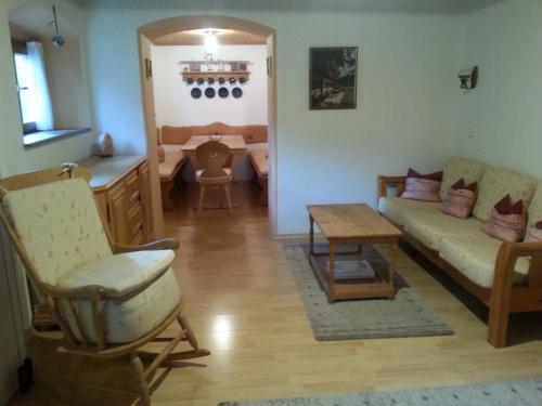 a living room with a couch and a table at Ferienhaus Kraihof, Münchner Straße 234 in Gmund am Tegernsee