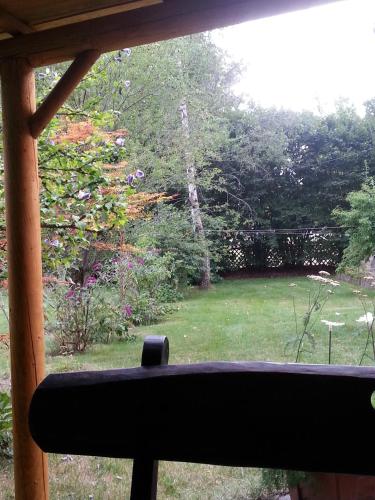 a view of a garden from the window of a house at Ferienhaus Kraihof, Münchner Straße 234 in Gmund am Tegernsee