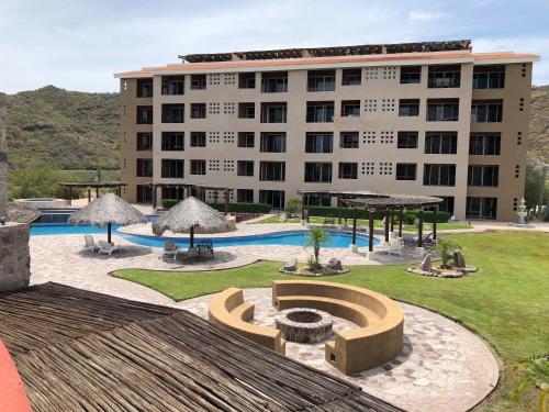 a hotel with a large building in the background at Marina Nopolo 413 in Loreto