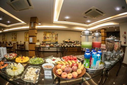 a buffet of food on a table in a hotel at Dall’Onder Vittoria Hotel Bento Gonçalves in Bento Gonçalves