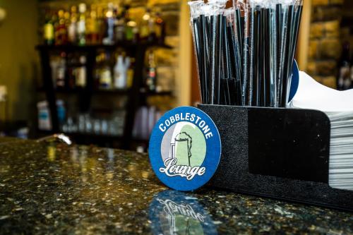 a badge on top of a counter in a bar at Cobblestone Inn & Suites-Winterset in Winterset