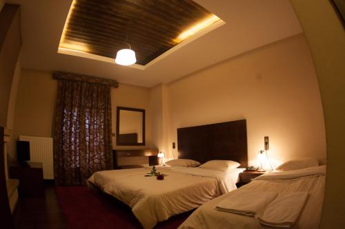Postel nebo postele na pokoji v ubytování Titagion Hotel