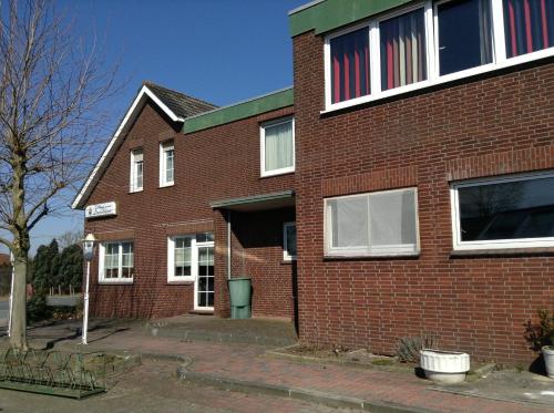 a brick building with an american flag in the window at Hotel Rotbuche in Westoverledingen
