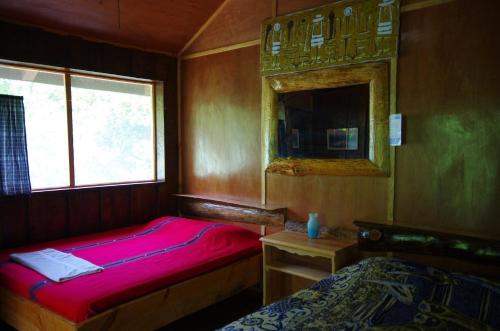 Postel nebo postele na pokoji v ubytování Utopia Eco Hotel