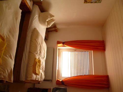 a bedroom with two bunk beds and a window at Hotel Rotbuche in Westoverledingen