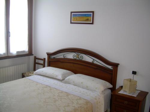 a bedroom with a bed with two pillows on it at Ariabuona in Moneglia