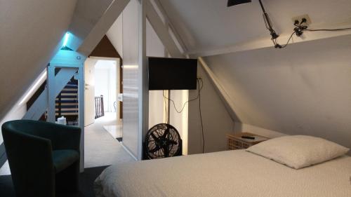 a bedroom with a bed and a stairway with a staircase at Résidence Surmont in Ieper