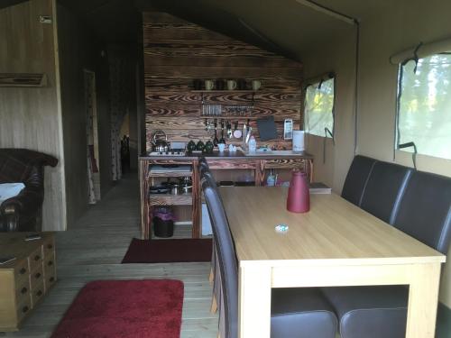 a dining table and chairs in a tiny house at Lincolnshire Glamping in Horncastle