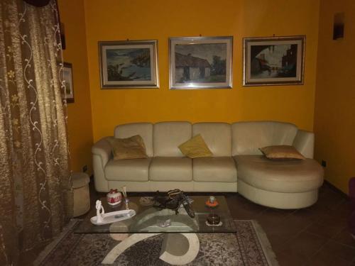 a living room with a couch and a table at Mirella's House ViaVerona in Ardea