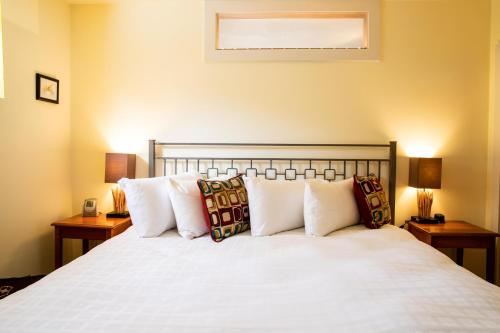 a bedroom with a large white bed with pillows at The Woodstocker B&B in Woodstock