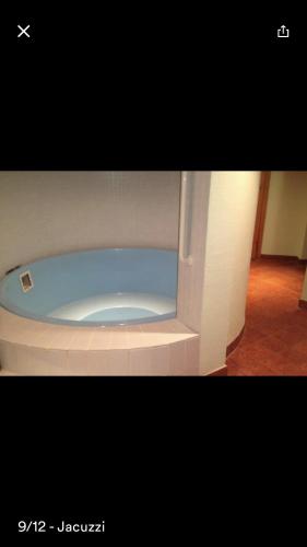 a white toilet with a blue seat in a room at Flims Chalet in Flims