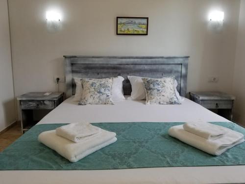 a bedroom with a large white bed with two pillows at Riviera Inn apartments in Ulcinj