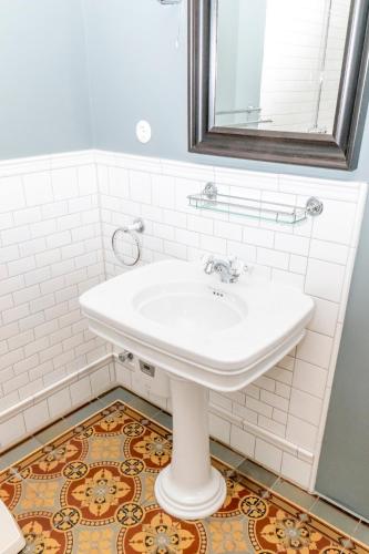 a bathroom with a white sink and a mirror at Historisches Bauernhaus Fehmarn in Strukkamp auf Fehmarn