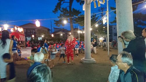 a group of people standing around a crowd at night at Live Cafe Hisui no Umi in Itoigawa