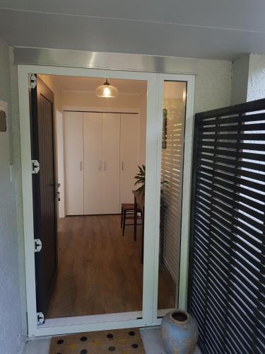 a door leading to a dining room with a table at Garden Retreat in Otaki