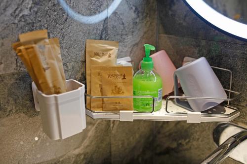 a shelf with a bottle and other items on it at Riverside Peak Lodge Zhangjiajie Wulingyuan National Park in Zhangjiajie