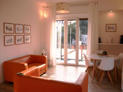 a living room with a couch and a table at Bright apartment in Cagliari