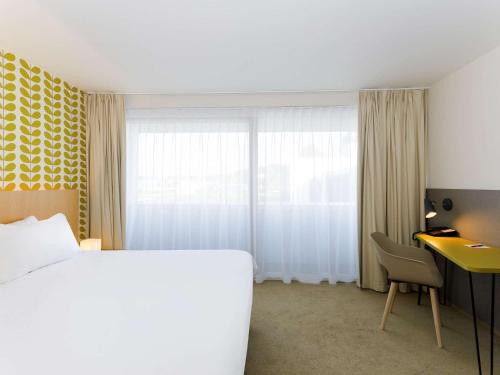 Cama o camas de una habitación en ibis Styles Kortrijk Expo