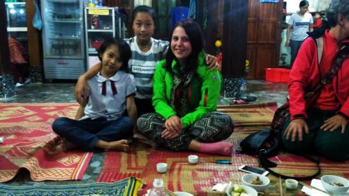 a group of people sitting on the floor at Cò's House in Mai Chau