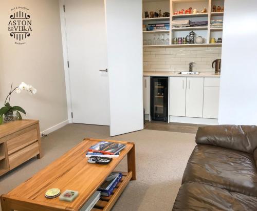 uma sala de estar com um sofá e uma mesa de centro em Aston Road Villa Bed & Breakfast em Waikanae