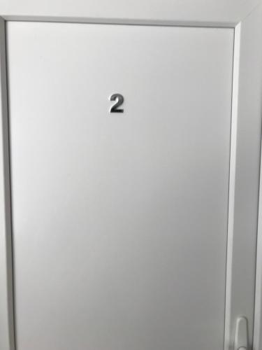 a white door with the number two on it at Vila de lux in Bela Crkva