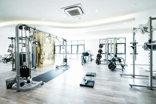 a gym with several treadmills and machines at P Plus Hotel in Pattaya Central