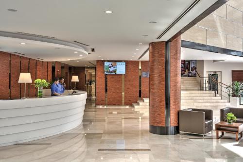 a lobby of a building with a reception counter at Oakwood Hotel & Residence Kuala Lumpur in Kuala Lumpur