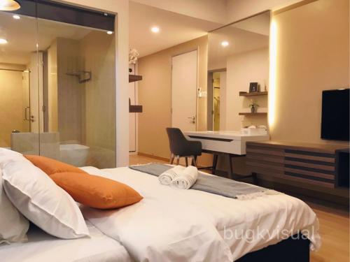 a bedroom with a large bed with a sink and a desk at Luxury Seaview Family Suite by Little Cabin in George Town
