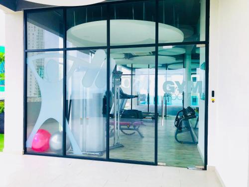 a large glass window with a dress in it at Luxury Seaview Family Suite by Little Cabin in George Town
