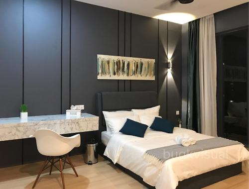a bedroom with a bed and a table and a chair at Luxury Seaview Family Suite by Little Cabin in George Town