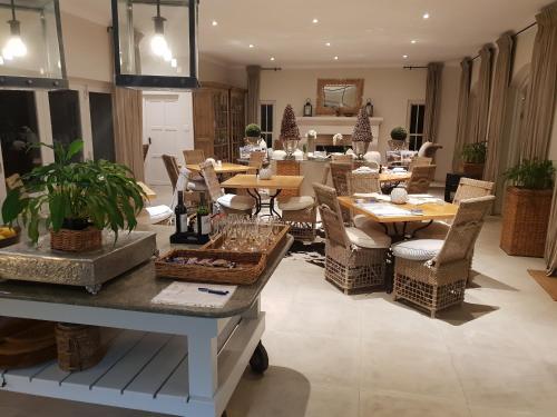 a dining room with tables and chairs at Maison d'Ail Guest House in Franschhoek