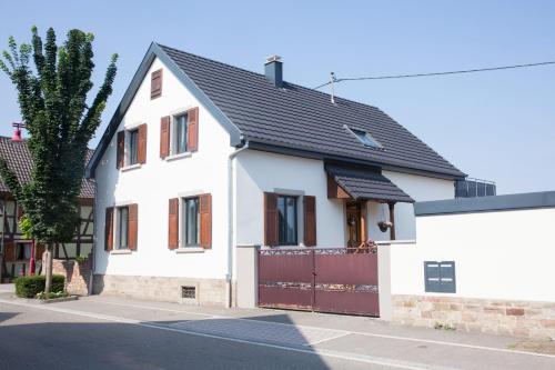 a white house with a black roof at Gite Jehl GO10 in Artolsheim