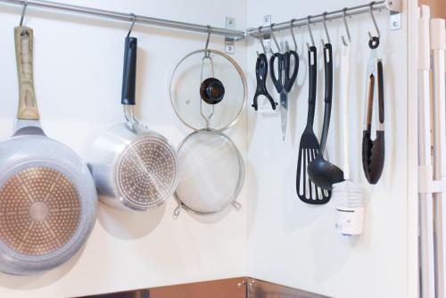 a bunch of kitchen utensils hanging on a wall at Yoyogi House in Tokyo
